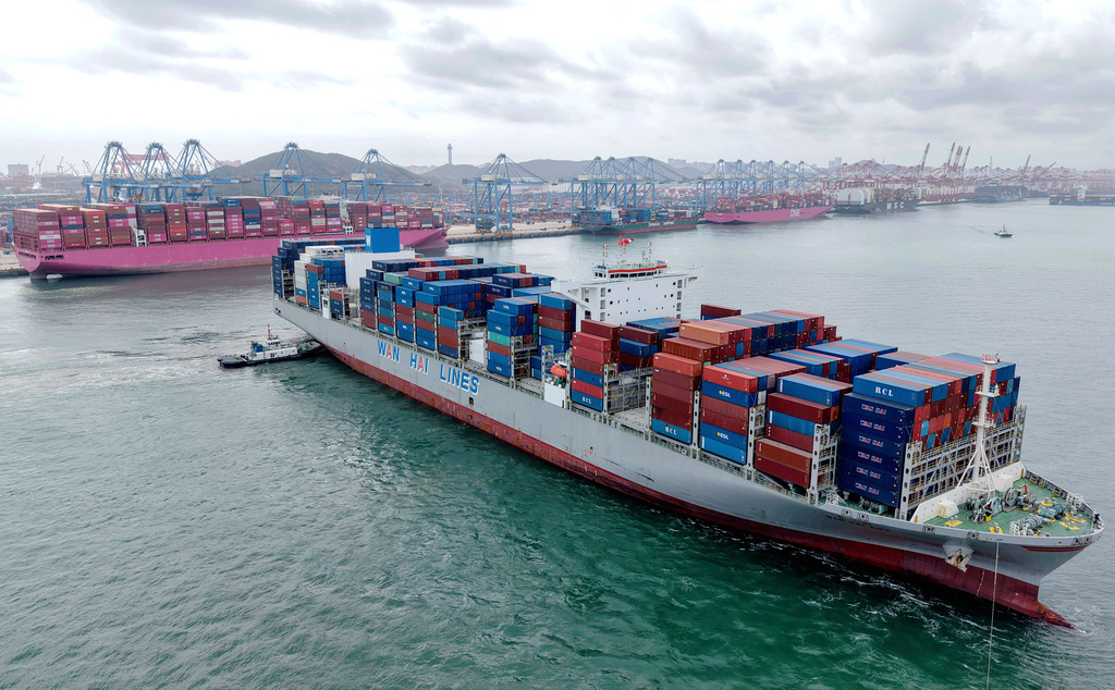 A container ship is seen near the terminal in Qingdao in eastern China's Shandong province on Thursday, Oct. 9, 2025. (Chinatopix Via AP)
