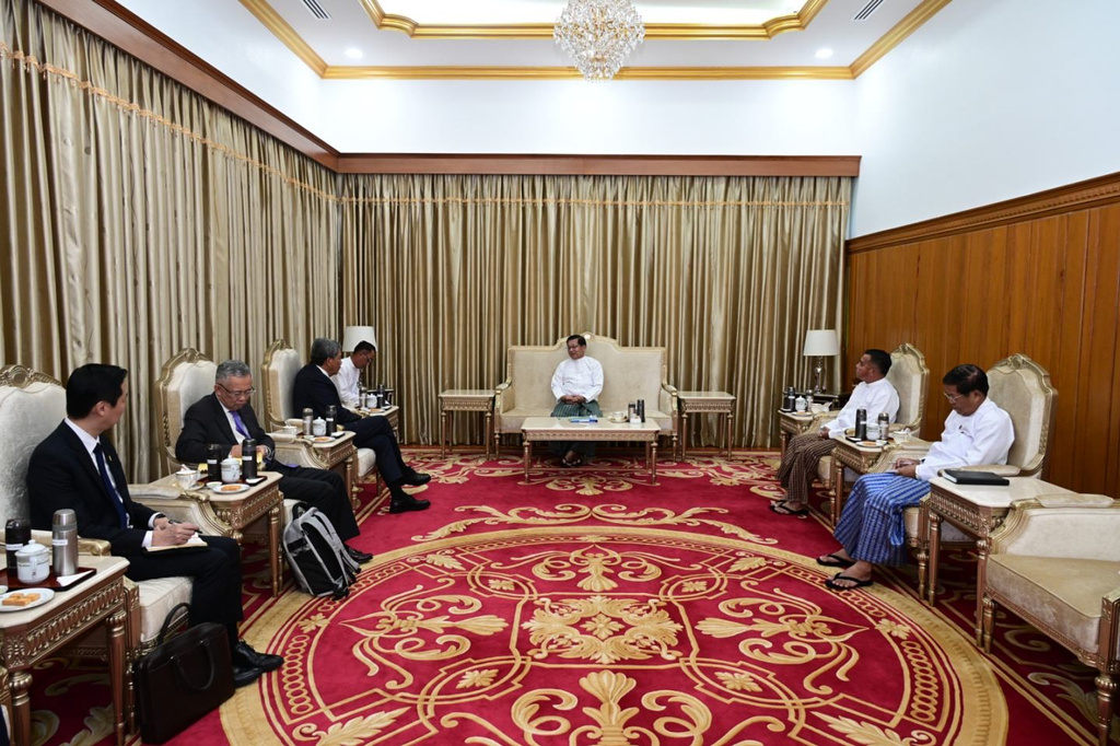In this image provided by the Myanmar Military True News Information Team, Myanmar military leader Senior Gen. Min Aung Hlaing, center, talks with Malaysian Foreign Minister Mohamad Hasan, third from left, during their meeting at the military guest house in Naypyitaw, Myanmar, Thursday, Oct. 9, 2025. (The Myanmar Military True News Information Team via AP)