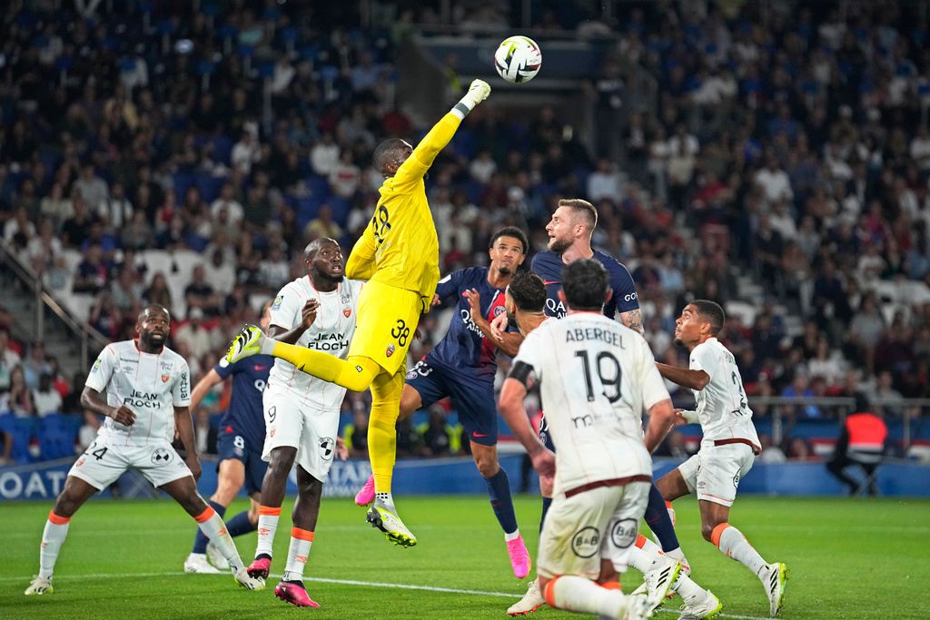 FILE - Lorient's goalkeeper Yvon-Lamdry Mvogo punches the ball clear during the French League One soccer match between Paris Saint-Germain and Lorient at the Parc des Princes stadium in Paris, Aug. 12, 2023. (AP Photo/Michel Euler, File)