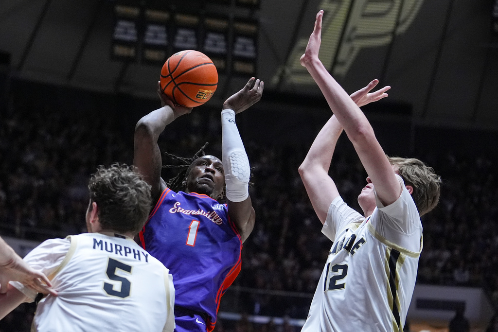 Evansville guard Keishon Porter (1) shoots over Purdue forward Liam Murphy (5) and center Daniel Jacobsen (12) during the first half of an NCAA college basketball game in West Lafayette, Ind., Tuesday, Nov. 4, 2025. (AP Photo/Michael Conroy)