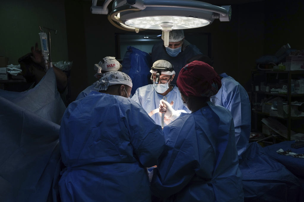 FILE - Doctors perform surgery on a patient at Al-Aqsa Martyrs Hospital, in Deir al-Balah, central Gaza, on March 17, 2024. (AP Photo/Abdel Kareem Hana, File)