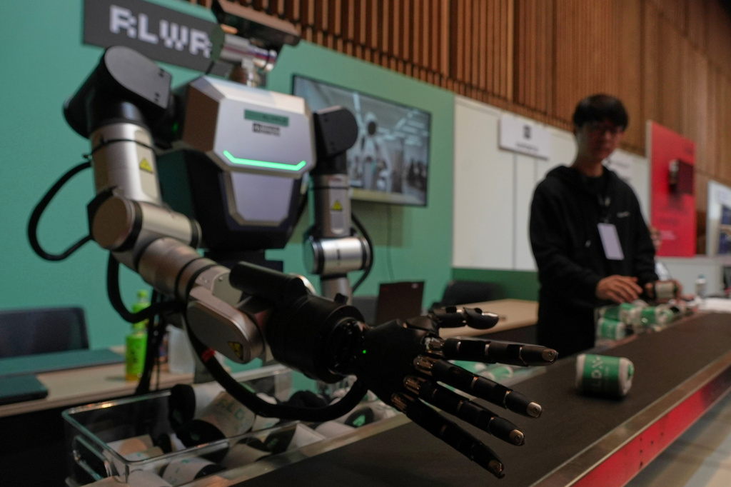 A robot demonstrates picking up a pair of socks at the Humanoids Summit 2026 in Tokyo, Thursday, May 28, 2026. (AP Photo/Ayaka McGill)