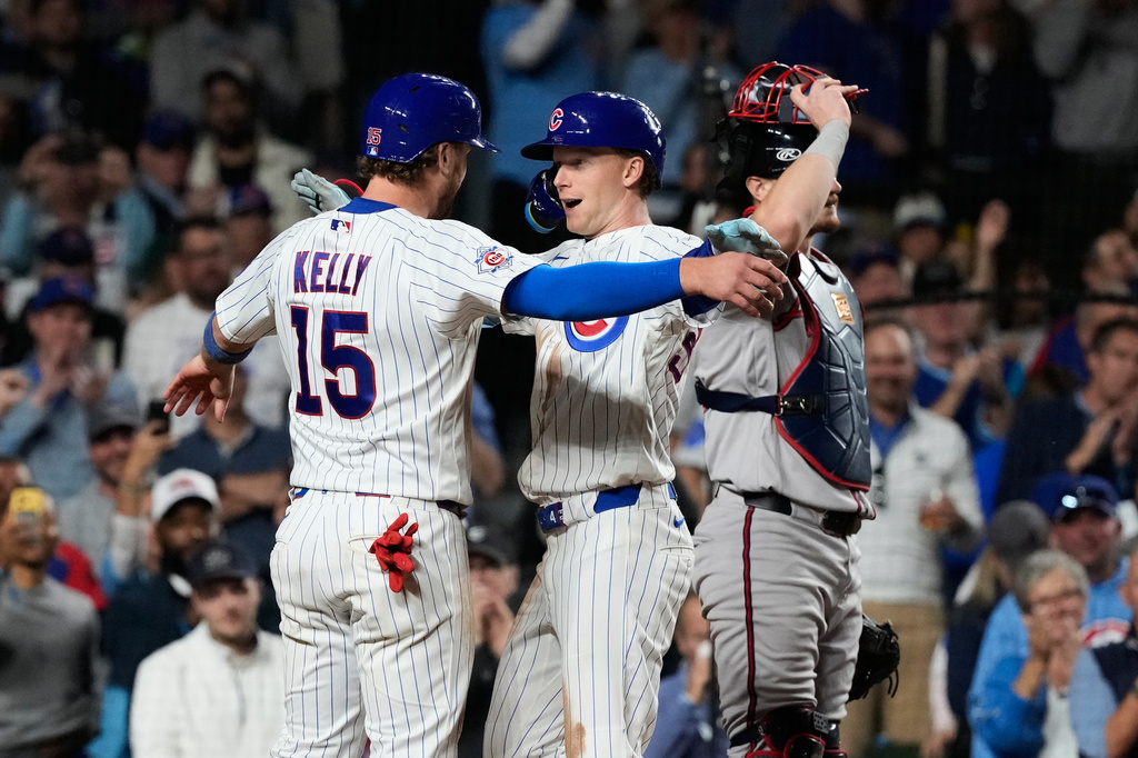 Chicago Cubs' Pete Crow-Armstrong, center, celebrates with Carson Kelly, left, after hitting a two-run home run as Atlanta Braves catcher Sean Murphy looks to the field during the sixth inning of a baseball game in Chicago, Monday, Sept. 14, 2026. (AP Photo/Nam Y. Huh)
