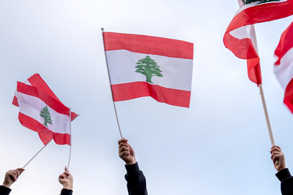 FILE - People wave Lebanese flags during a vigil, April 10, 2026, in Dearborn, Mich. (AP Photo/Julia Demaree Nikhinson, File)