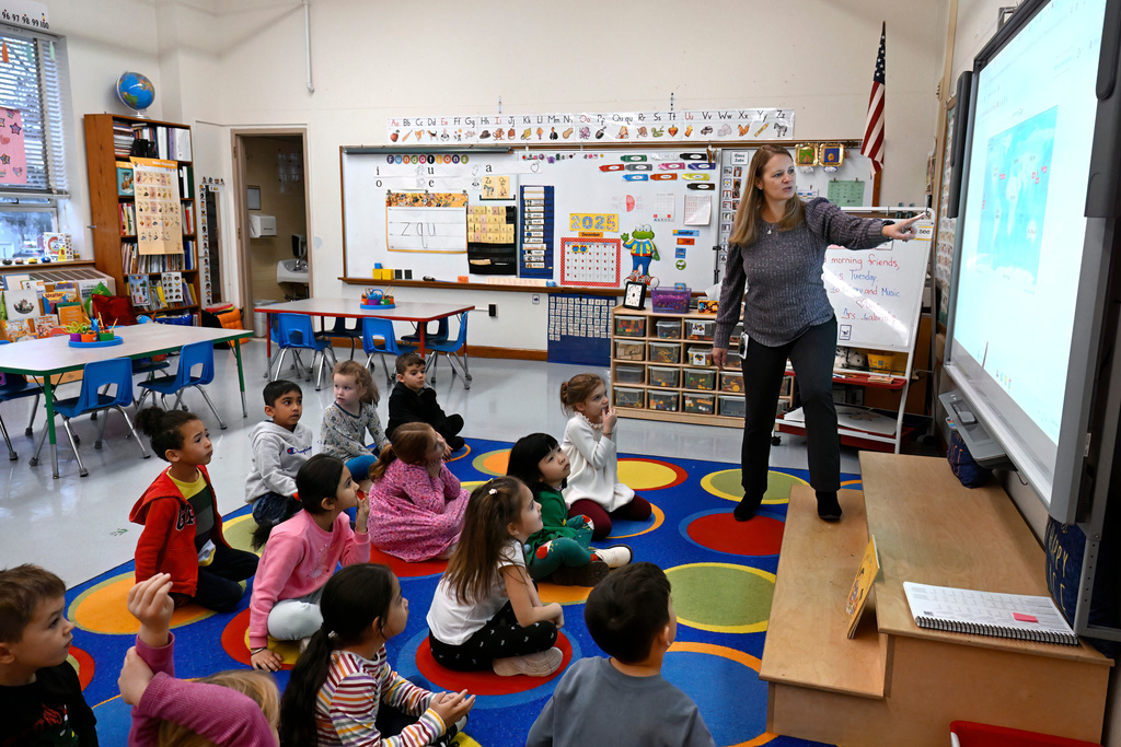 Kindergarten teacher Christin Labriola points out Hawaii on a map, incorporating Asian American and Pacific Islander subjects in her class at Webster Hill Elementary School in West Hartford, Conn., on Dec. 2, 2025. (AP Photo/Jessica Hill)