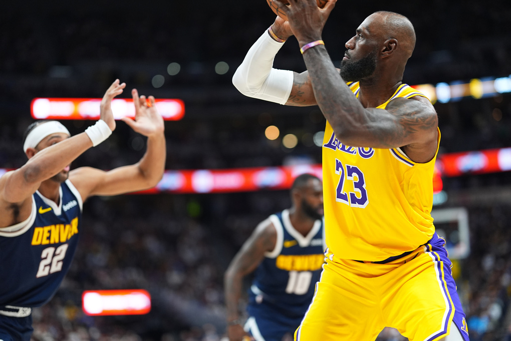 Los Angeles Lakers forward LeBron James, right, shoots a field goal to surpass Kareem Abdul-Jabbar's record of 15,837 to become the NBA's all-time leader in field goals as Denver Nuggets forward Zeke Nnaji defends in the first half of an NBA basketball game, Thursday, March 5, 2026, in Denver. (AP Photo/David Zalubowski)