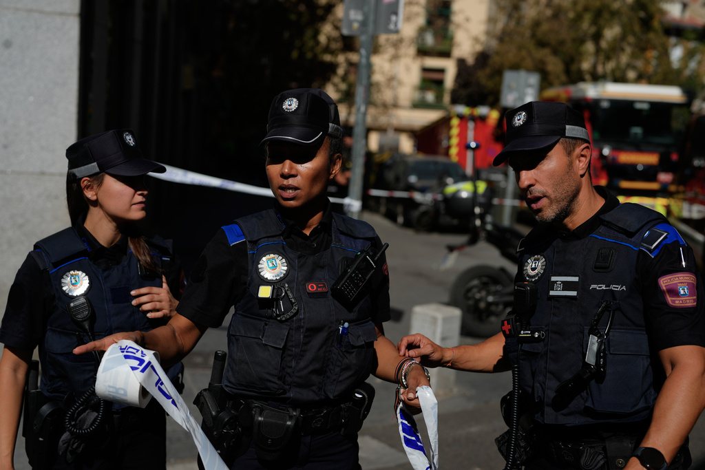 Police rope off an area as emergency personnel respond to the scene of a building collapse in Madrid, Spain, on Tuesday, Oct. 7, 2025. (AP Photo/Manu Fernandez)
