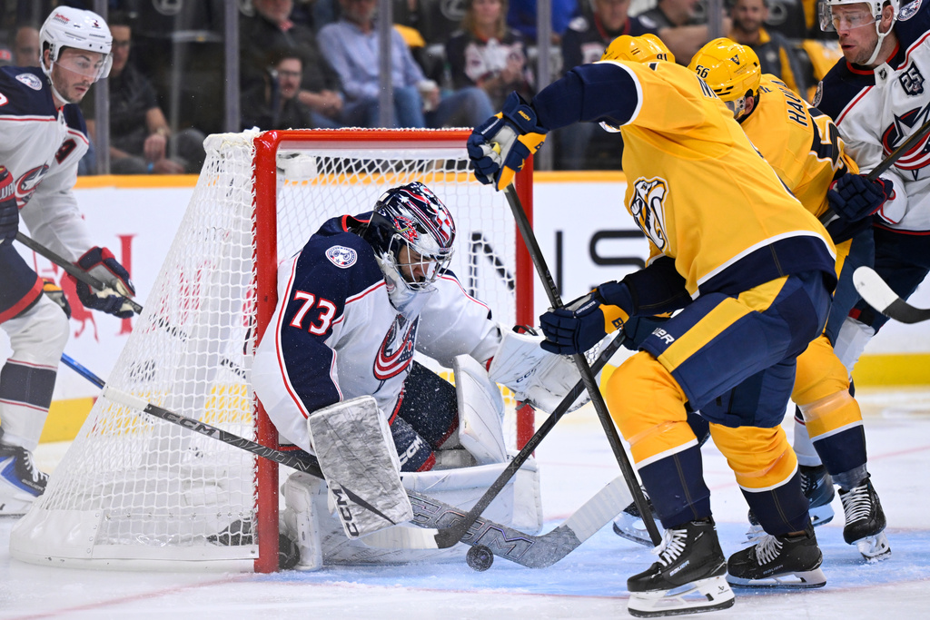 Columbus Blue Jackets goaltender Jet Greaves (73) makes a save on a shot by Nashville Predators center Jonathan Marchessault, front right, during the second period of an NHL hockey game Thursday, Oct. 9, 2025, in Nashville, Tenn. (AP Photo/John Amis)
