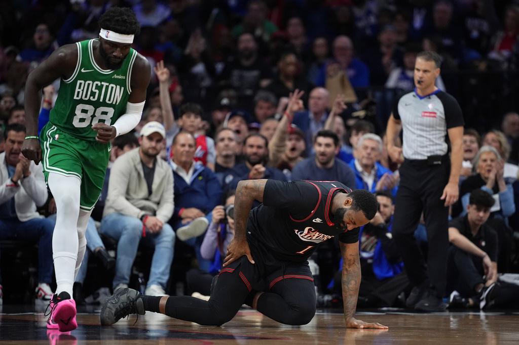 Philadelphia 76ers' Andre Drummond, right, reacts past Boston Celtics' Neemias Queta after an injury during the first half of Game 4 in a first-round NBA basketball playoffs series Sunday, April 26, 2026, in Philadelphia. (AP Photo/Matt Slocum)