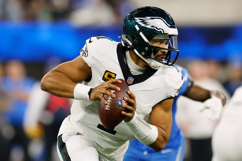 Philadelphia Eagles quarterback Jalen Hurts (1) rolls out during the second half of an NFL football game against the Los Angeles Chargers, Monday, Dec. 8, 2025, in Inglewood, Calif. (AP Photo/Caroline Brehman)