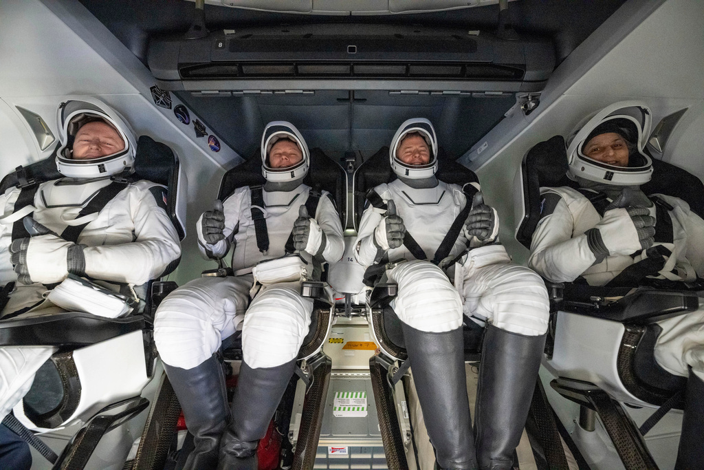 FILE - From left, NASA astronaut Butch Wilmore, Russia's Alexander Gorbunov, and NASA astronauts Nick Hague and Suni Williams sit inside a SpaceX capsule onboard the SpaceX recovery ship Megan after landing in the water off the coast of Florida, March 18, 2025. (Keegan Barber/NASA via AP, File)