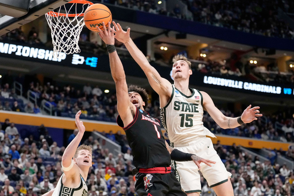 Louisville guard J'vonne Hadley (1) is blocked by Michigan State center Carson Cooper (15) during the second half in the second round of the NCAA college basketball tournament, Saturday, March 21, 2026, in Buffalo, N.Y. (AP Photo/Yuki Iwamura)