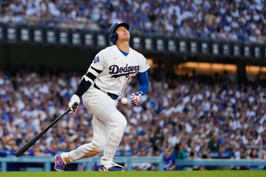 Los Angeles Dodgers designated hitter Shohei Ohtani reacts after fouling a pitch off of himself during the fifth inning of an opening-day baseball game against the Arizona Diamondbacks Thursday, March 26, 2026, in Los Angeles. (AP Photo/Mark J. Terrill)