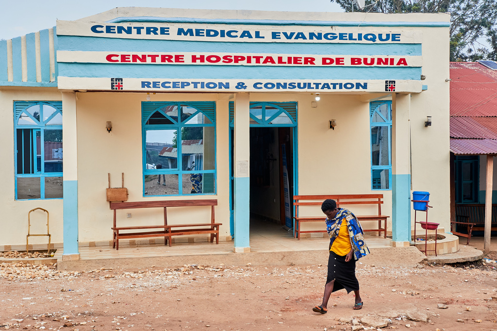 A woman walk past the Evangelical Medical Center, in Bunia, eastern Congo, Friday, July 3, 2026, where Ebola clinical trials are scheduled to take place, (AP Photo/Dirole Lotsima Dieudonne)