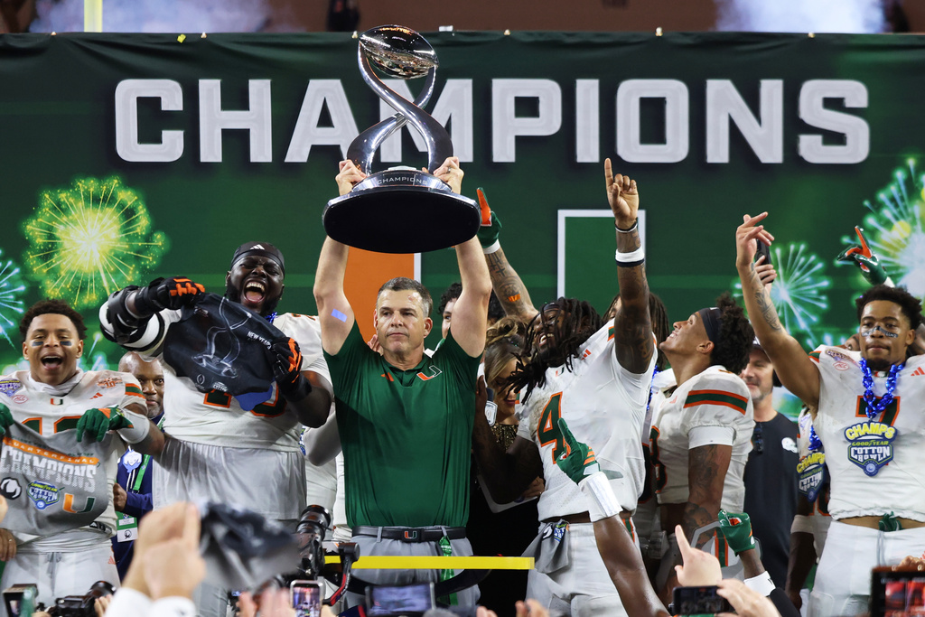 Miami head coach Mario Cristobal holds the Field Scovell Trophy following the Cotton Bowl College Football Playoff quarterfinal game against Ohio State Wednesday, Dec. 31, 2025, in Arlington, Texas. (AP Photo/Gareth Patterson)