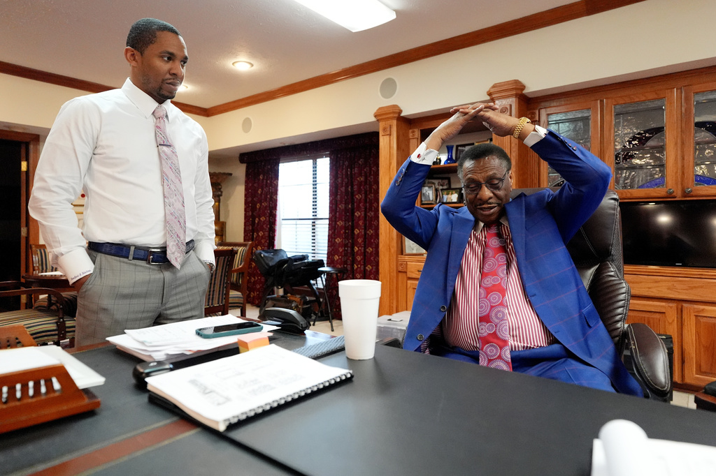 Attorney Edward Blackmon Jr., 78, a civil rights attorney and a former state representative, right, demonstrates how he and other civil rights marchers were taught how to protect themselves if physically set upon by lawmen to his son State Sen. Bradford Blackmon, D-Canton, in Canton, Miss., Friday, May 1, 2026. (AP Photo/Rogelio V. Solis)