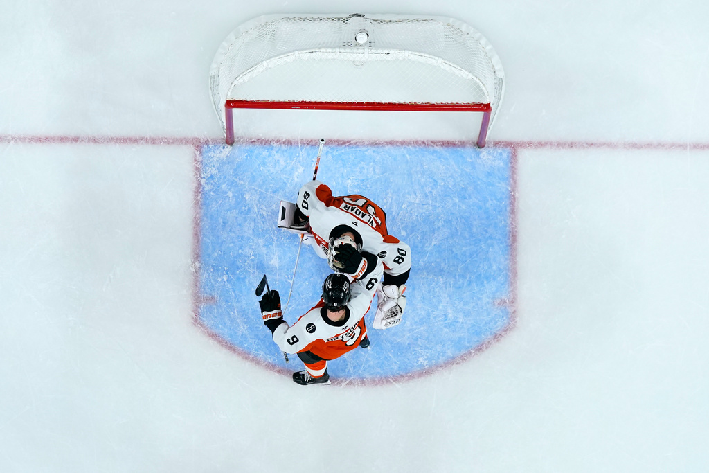 Philadelphia Flyers' Jamie Drysdale (9) and Dan Vladar (80) celebrate after an NHL hockey game against the Nashville Predators Thursday, Oct. 30, 2025, in Philadelphia. (AP Photo/Matt Slocum)