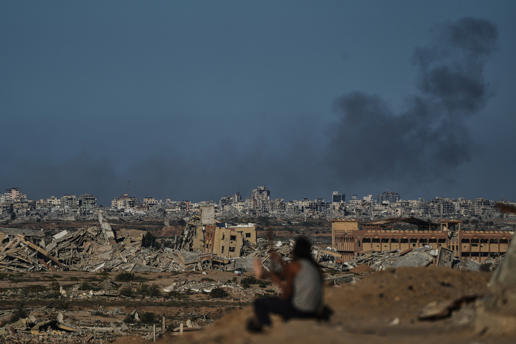 Smoke rises following an Israeli military strike in Gaza City, as seen from the central Gaza Strip, Tuesday, Oct. 7, 2025. (AP Photo/Abdel Kareem Hana)