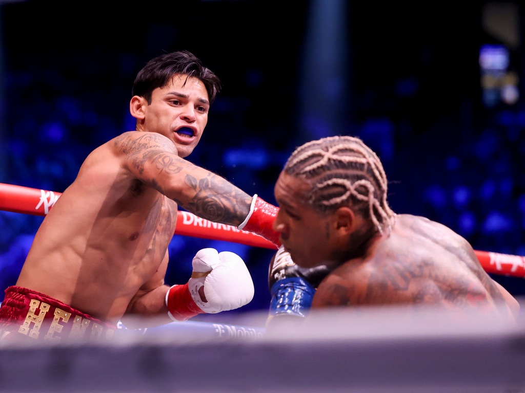 Ryan Garcia, left, punches Conor Benn in their welterweight championship fight Saturday, Sept. 12, 2026, in Las Vegas. (AP Photo/Ian Maule)