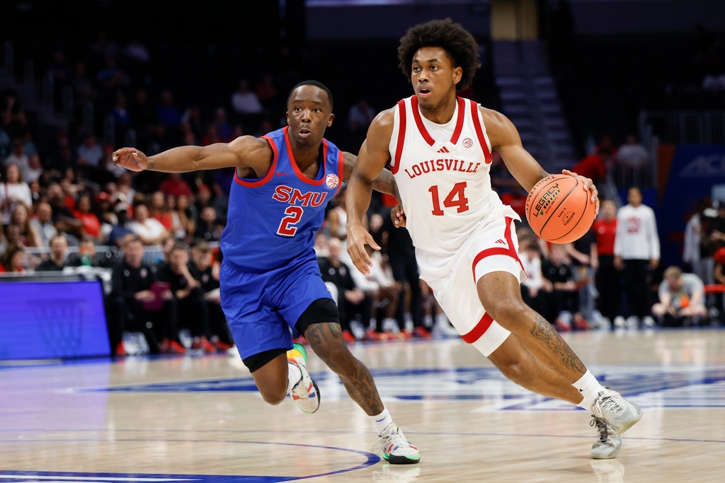 Louisville guard Adrian Wooley (14) drives against SMU guard Boopie Miller during the first half of an NCAA college basketball game in the second round of the Atlantic Coast Conference tournament in Charlotte, N.C., Wednesday, March 11, 2026. (AP Photo/Nell Redmond)
