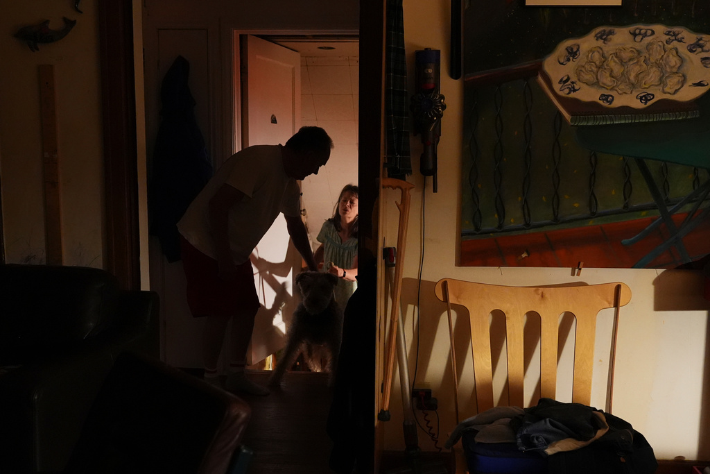Ross Colquhoun wakes up his wife Mary E. Brunkow to talk about her winning a Nobel Prize in medicine for part of her work on peripheral immune tolerance, in Seattle, Monday, Oct. 6, 2025. (AP Photo/Lindsey Wasson)