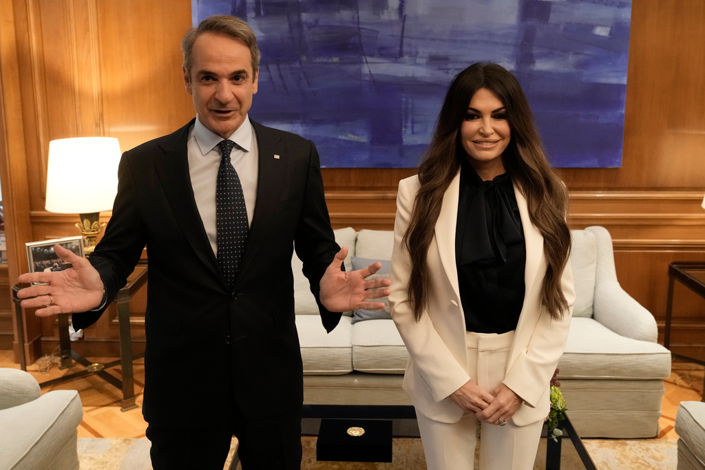 Greece's Prime Minister Kyriakos Mitsotakis, left, welcomes Kimberly Guilfoyle, the new U.S. Ambassador to Greece, at Maximos Mansion in Athens, Greece, Wednesday, Nov. 5, 2025. (AP Photo/Thanassis Stavrakis)