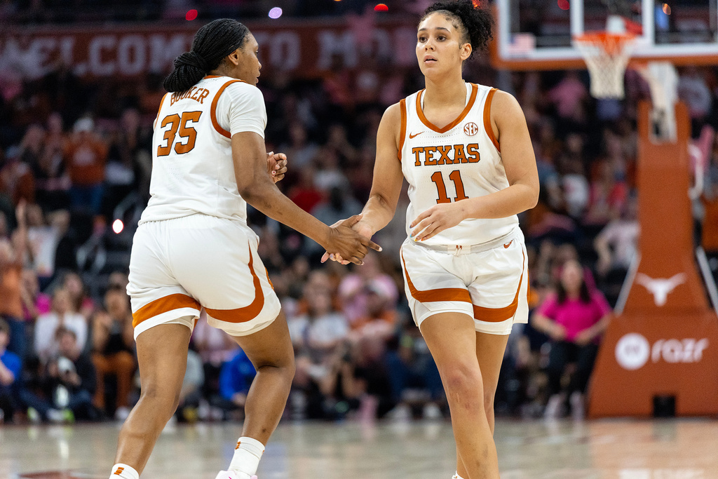 Texas forward Justice Carlton (11) celebrates after a 3-point basket against Kentucky with forward Madison Booker (35) during the second half of an NCAA college basketball game Monday, Feb. 9, 2026, in Austin, Texas. (AP Photo/Stephen Spillman)