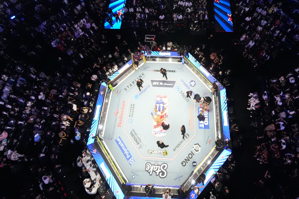 Alex Pereira, far right, is attended to, as Ciryl Gane lays in the center of the ring during UFC Freedom 250 on the South Lawn of the White House, Monday, June 15, 2026, in Washington. (AP Photo/Alex Brandon, Pool)