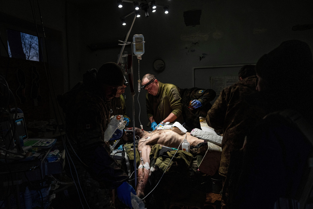 FILE - Ukrainian military doctors treat an injured comrade who was evacuated from the battlefield in a hospital in the Donetsk region, Ukraine, Monday, Jan. 9, 2023. The serviceman did not survive. (AP Photo/Evgeniy Maloletka, File)