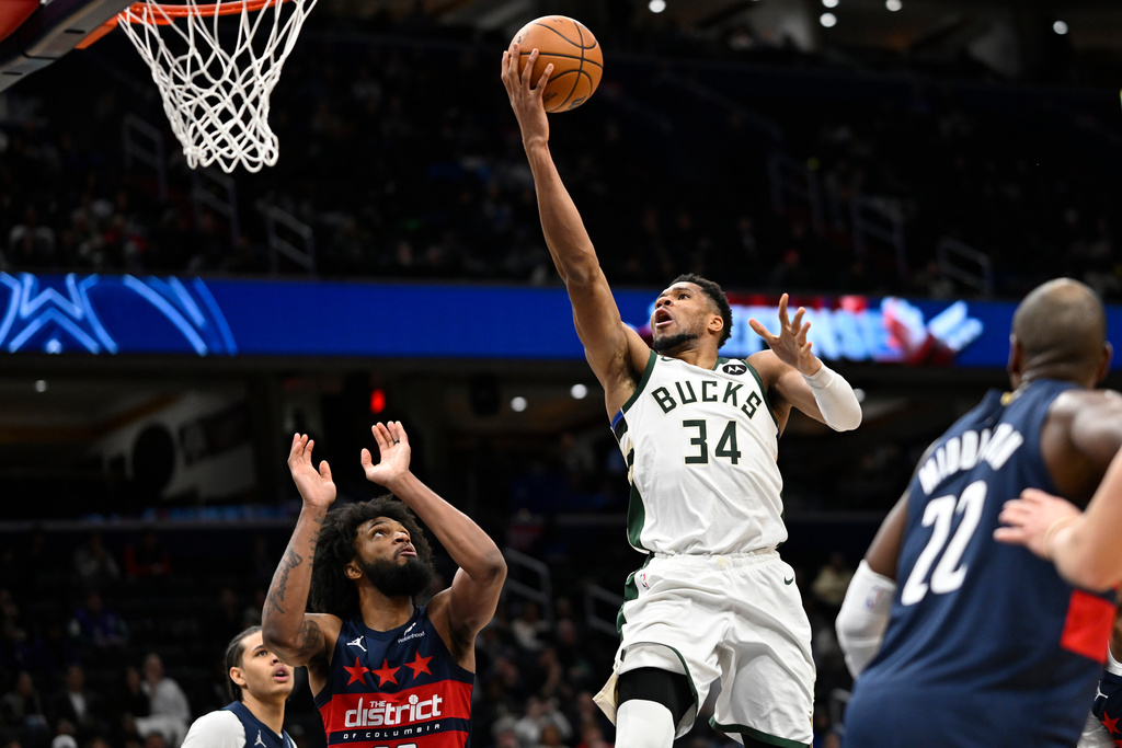 Milwaukee Bucks forward Giannis Antetokounmpo (34) goes up to score during the second half of an NBA basketball game against the Washington Wizards, Monday, Dec. 1, 2025, in Washington. (AP Photo/John McDonnell)