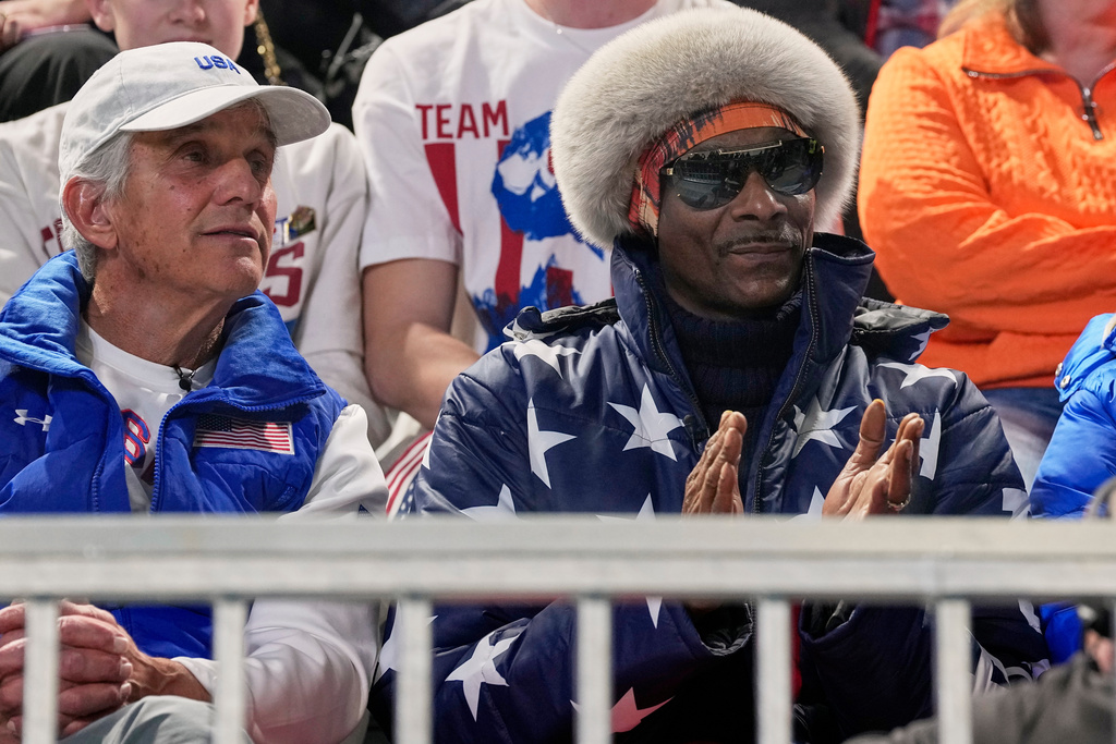 Snoop dog and five-time olympic gold medallist former speed skater Eric Heiden of the U.S. watch the men's 1,000 meters speedskating race at the 2026 Winter Olympics, in Milan, Italy, Wednesday, Feb. 11, 2026. (AP Photo/Ben Curtis)