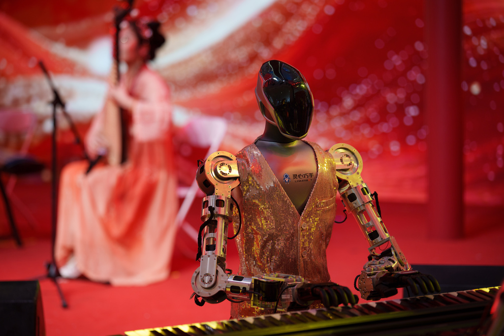 A robot accompanies a traditional music performance on stage at a Lunar New Year tech temple fair in Beijing, Feb. 19, 2026. (AP Photo/Vincent Thian)