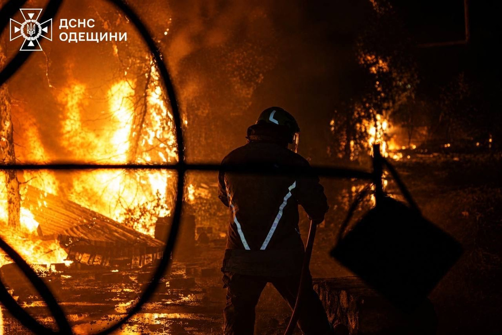 A Ukrainian firefighter puts out a fire after Russia struck the southern Odesa region overnight on Sunday, May 3, 2026. (Ukrainian Emergency Service via AP)