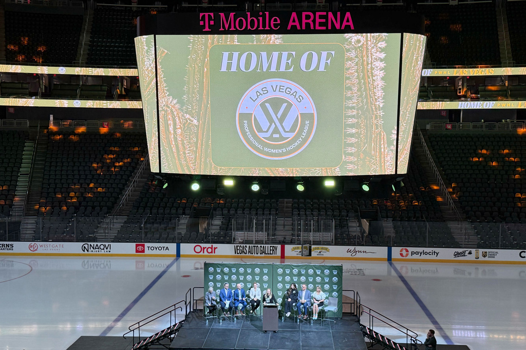 The NHL Network's Jamie Hersch, at podium, and officials announce the PWHL women's hockey expansion team beginning in the 2026-27 season, Wednesday, May 13, 2026 in Las Vegas. Hamilton, Ontario, also was added on Wednesday. (AP Photo/Mark Anderson