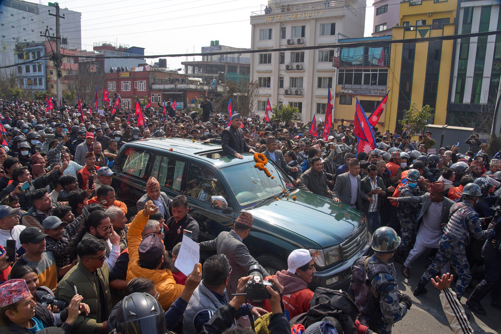 Supporters gather to welcome Nepal's former King Gyanendra Shah, center, upon his arrival at Tribhuvan International Airport in Kathmandu, Nepal, Friday, Feb. 13, 2026. (AP Photo/Niranjan Shrestha)