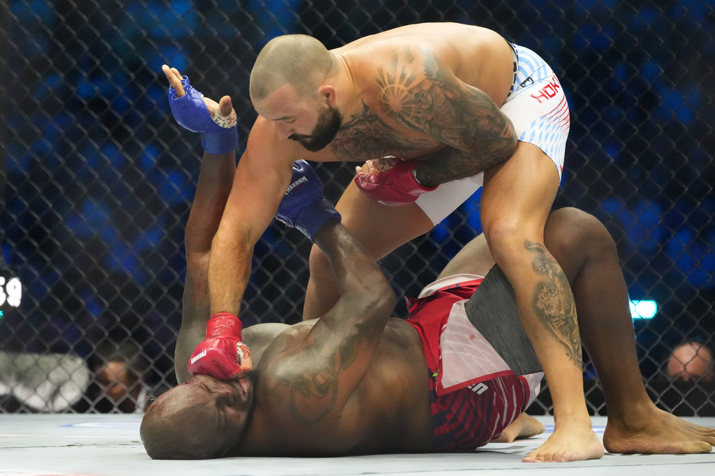 Josh Hokit lands a punch as he fights Derrick Lewis during their heavyweight bout at UFC Freedom 250 on the South Lawn of the White House, Sunday, June 14, 2026, in Washington. (AP Photo/Alex Brandon)