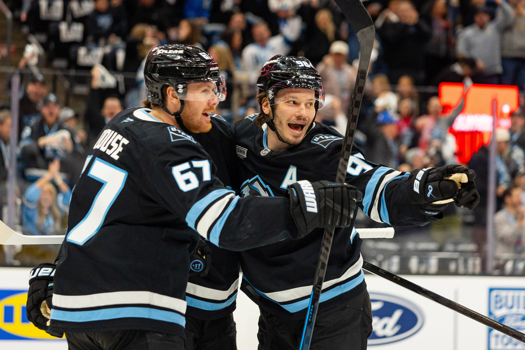 Utah Mammoth center Kevin Stenlund (obscured) celebrates with teammates after he scored against the Seattle Kraken during the first period of an NHL hockey game Saturday, Jan. 17, 2026, in Salt Lake City. (AP Photo/Melissa Majchrzak)
