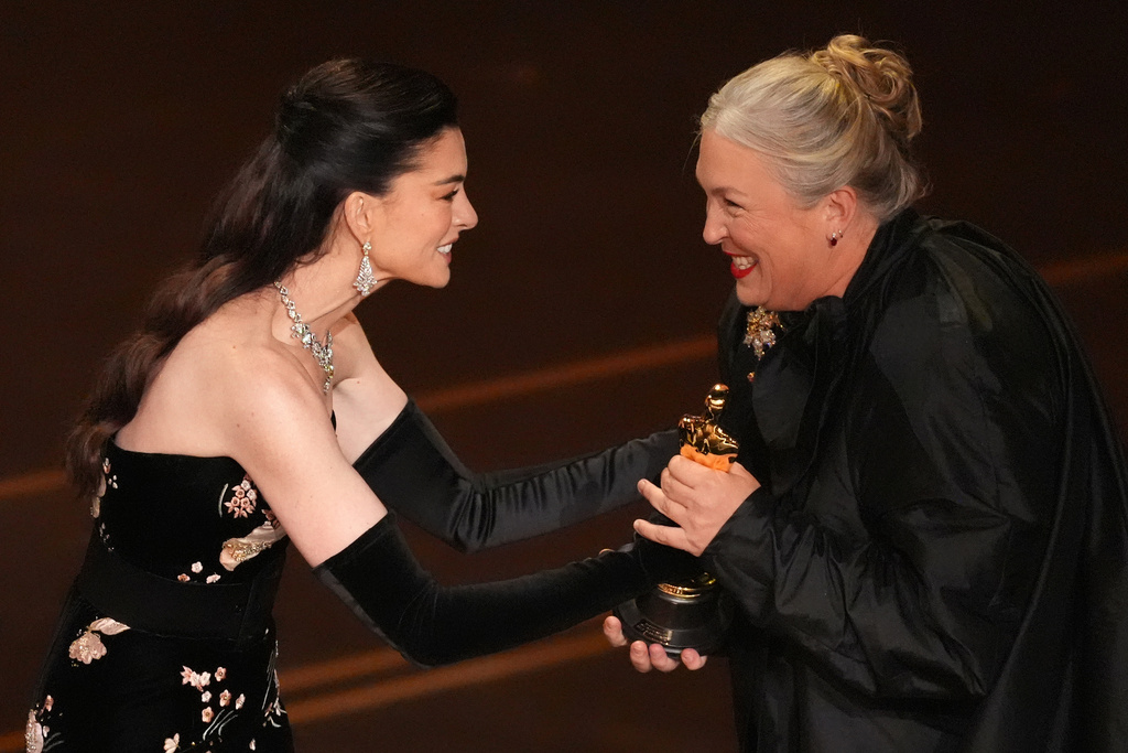Anne Hathaway presents the award for best costume design to Kate Hawley for "Frankenstein" during the Oscars on Sunday, March 15, 2026, at the Dolby Theatre in Los Angeles. (AP Photo/Chris Pizzello)