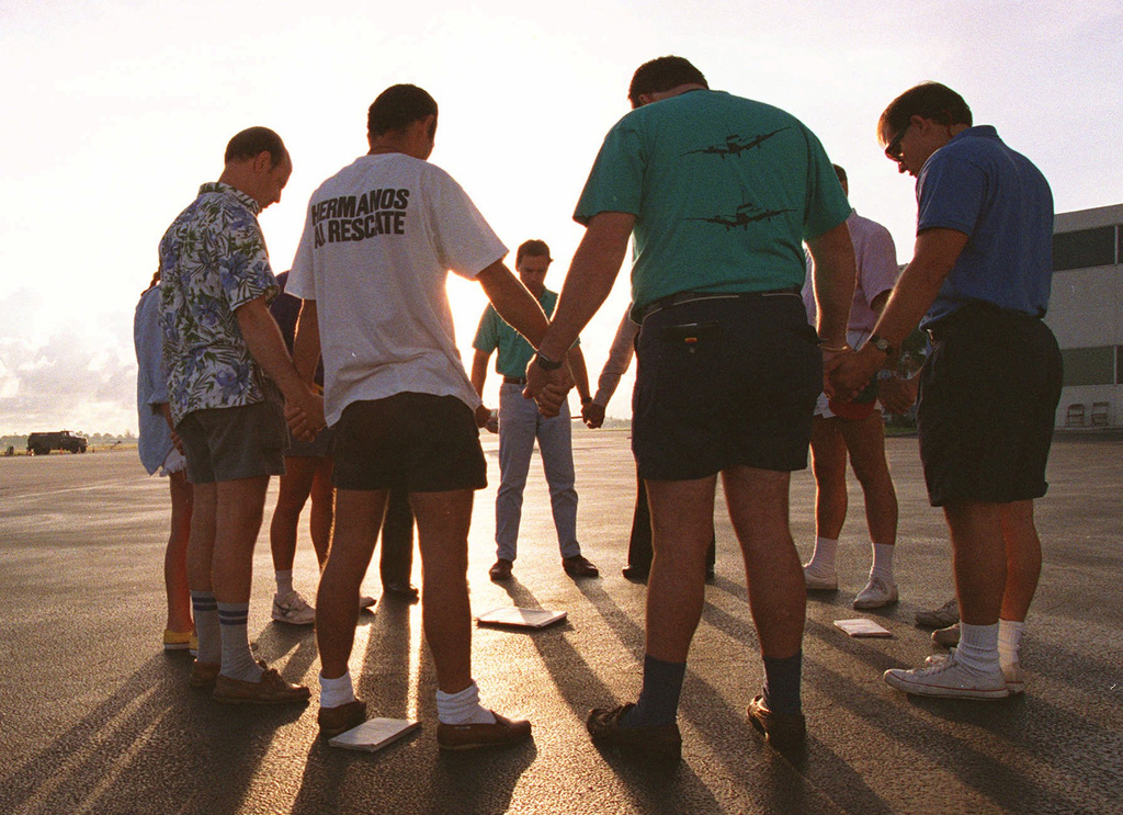 FILE - Brothers to the Rescue pilots pray before leaving on a mission from Opalocka Airport in Miami, Fla., Aug. 31, 1993. (AP Photo/Lynne Sladky, File)