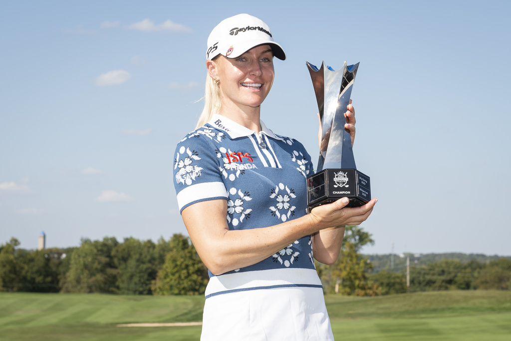 Charley Hull, of England, holds the trophy after winning the Kroger Queen City Championship golf tournament, Sunday, Sept. 14, 2025, at TPC River's Bend in Cincinnati. (AP Photo/Tanner Pearson)