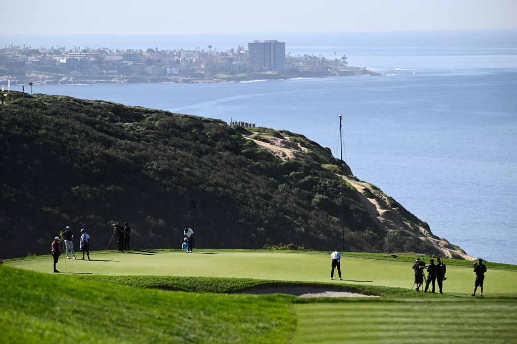 FILE - Justin Rose, of England, putts on the third green of the South Course at Torrey Pines during the final round of the Farmers Insurance Open golf tournament, Feb. 1, 2026, in San Diego. (AP Photo/Denis Poroy, file)