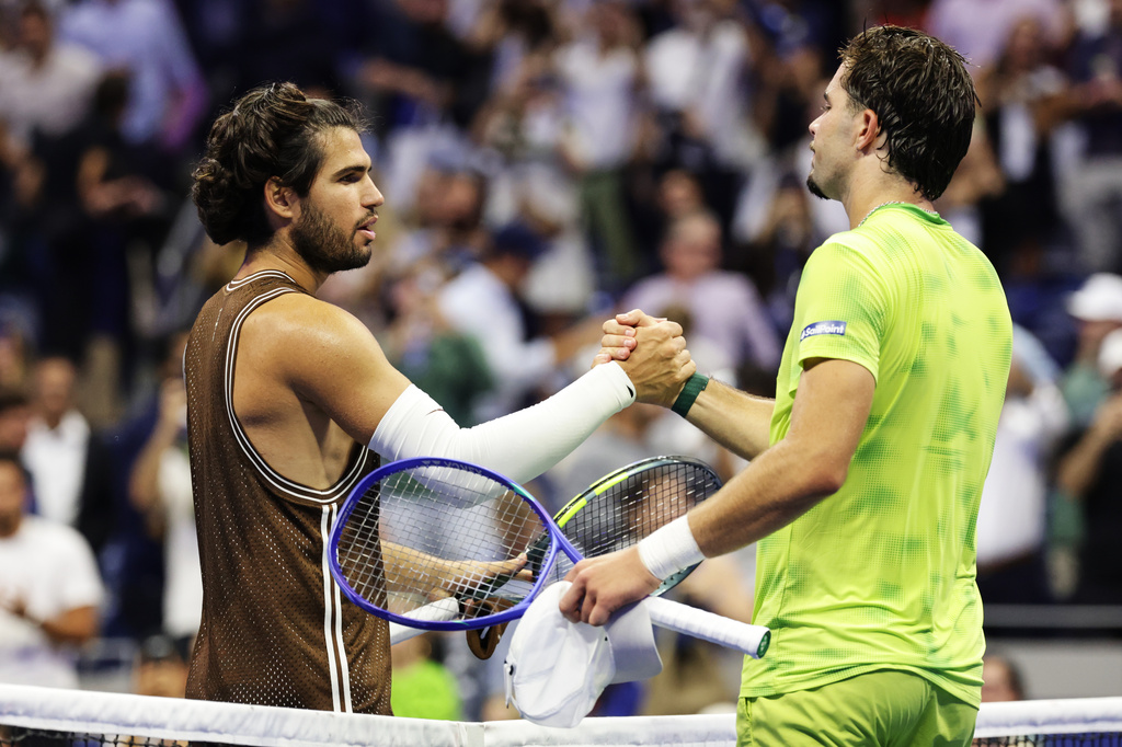 Carlos Alcaraz, of Spain, left, meets Jaime Faria, of Portugal, at the net after winning a match during the second round of the U.S. Open tennis championships, Wednesday, Sept. 2, 2026, in New York. (AP Photo/Adam Hunger)