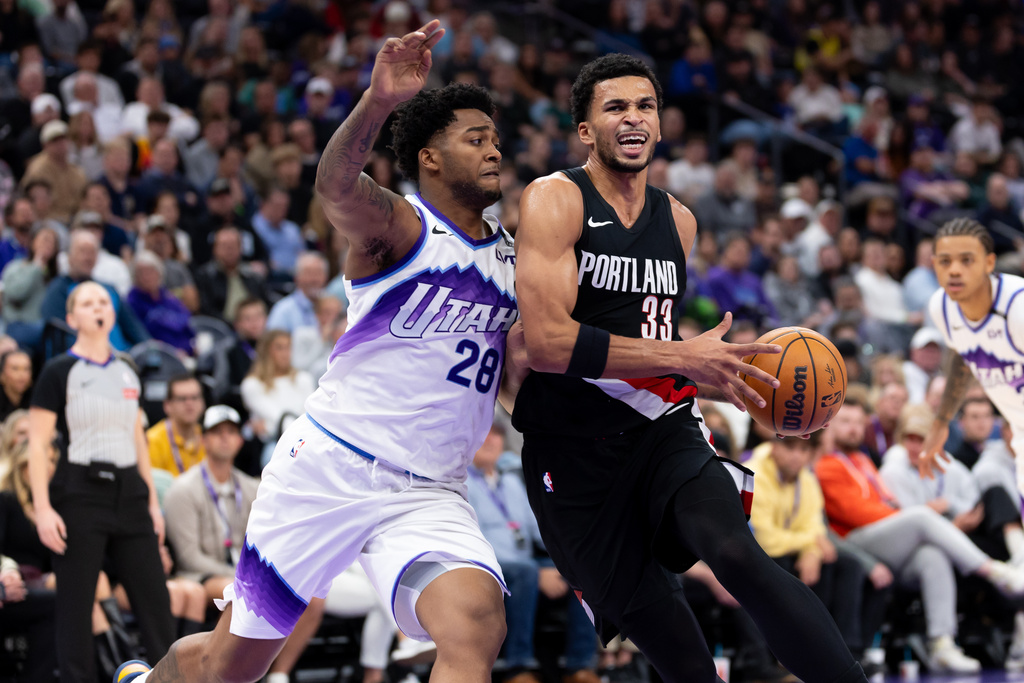 Utah Jazz forward Brice Sensabaugh (28) defends Portland Trailblazers forward Toumani Camara (33) during the first half of an NBA basketball game, Wednesday, Oct. 29, 2025, in Salt Lake City. (AP Photo/Anna Fuder)