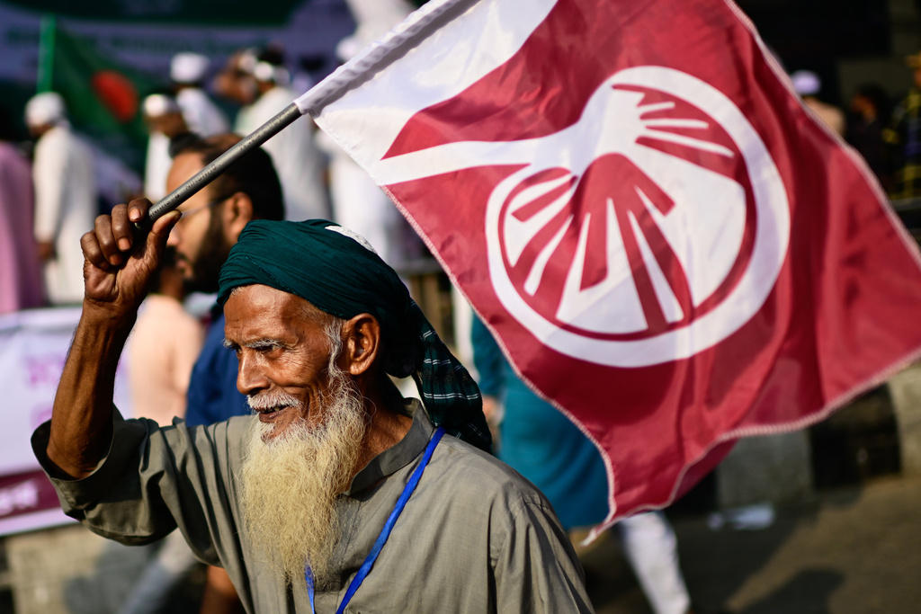 A supporter of Islami Andolan Bangladesh, an allied political party to Jamaat-e-Islami, attends a rally in which parties presented their demands before the next general election, expected to be held in February, in Dhaka, Bangladesh, Tuesday, Nov. 11, 2025. (AP Photo/Mahmud Hossain Opu)