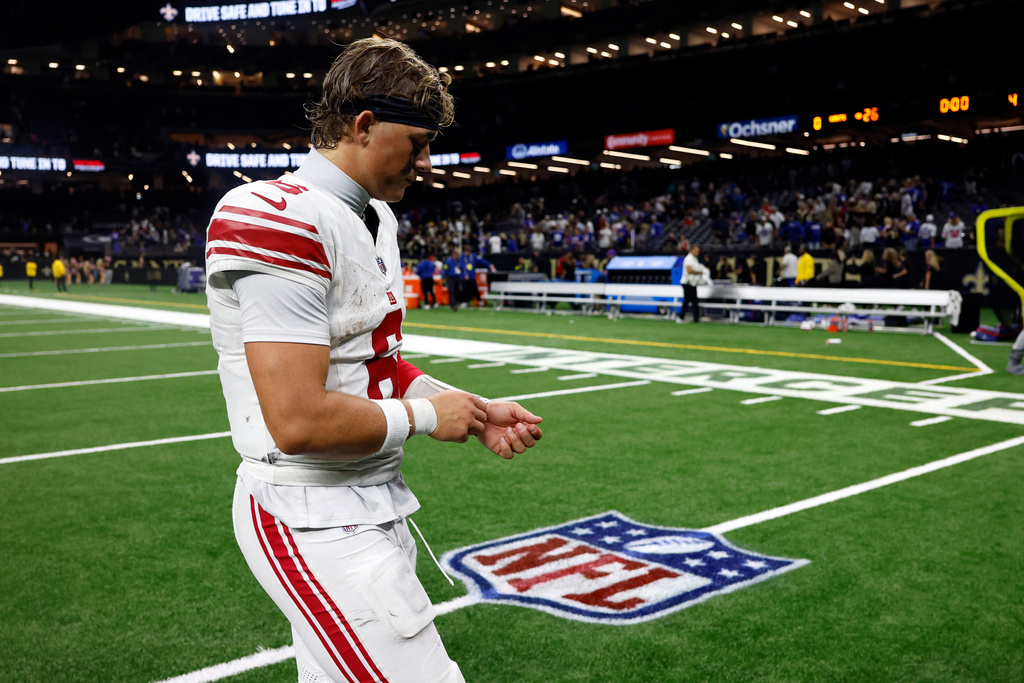 New York Giants quarterback Jaxson Dart walks off the field after a loss to the New Orleans Saints in an NFL football game, Sunday, Oct. 5, 2025, in New Orleans. (AP Photo/Butch Dill)