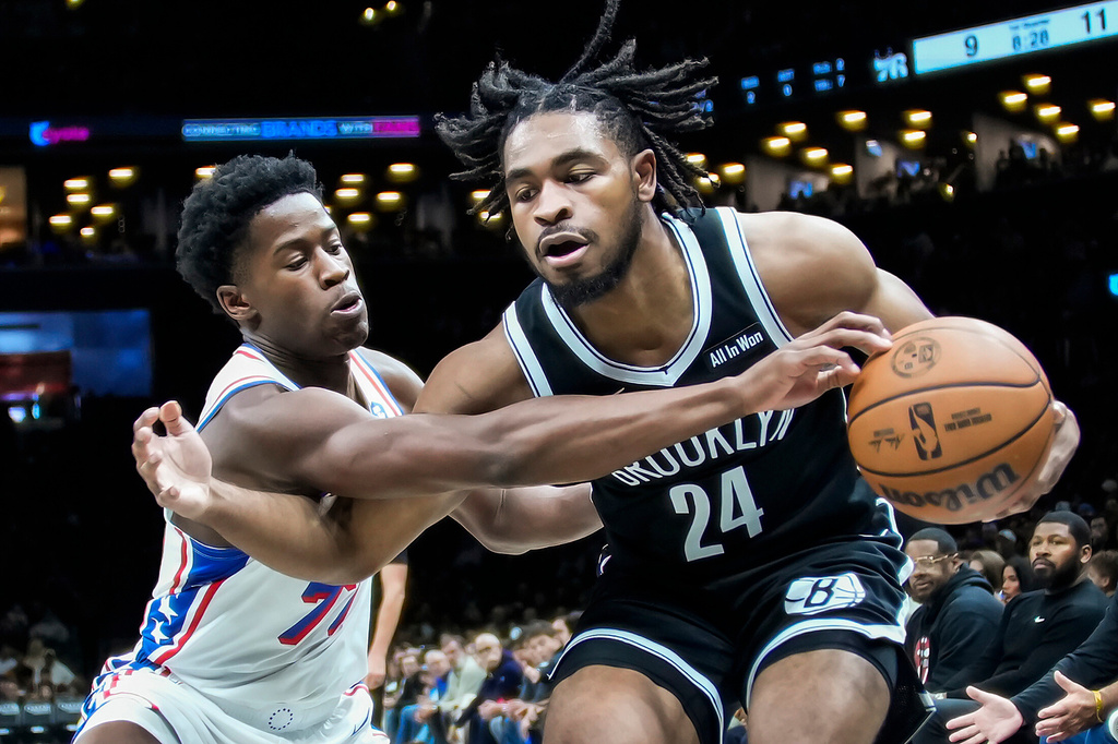 Brooklyn Nets' Cam Thomas (24) fights for the ball against Philadelphia 76ers' VJ Edgecombe, left, during the first half of an NBA basketball game Sunday, Nov. 2, 2025, in New York. (AP Photo/Eduardo Munoz Alvarez)