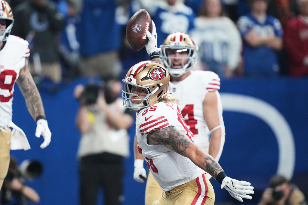 San Francisco 49ers tight end George Kittle, foreground, celebrates after scoring against the Indianapolis Colts during the first half of an NFL football game, Monday, Dec. 22, 2025, in Indianapolis. (AP Photo/AJ Mast)