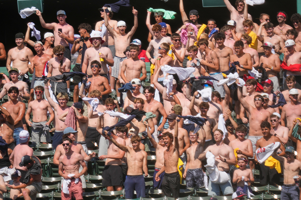With temperatures in the mid-90's, shirtless fans cheer during the eighth inning of a baseball game between the Boston Red Sox and Washington Nationals, Wednesday, July 1, 2026, in Boston. (AP Photo/Charles Krupa)