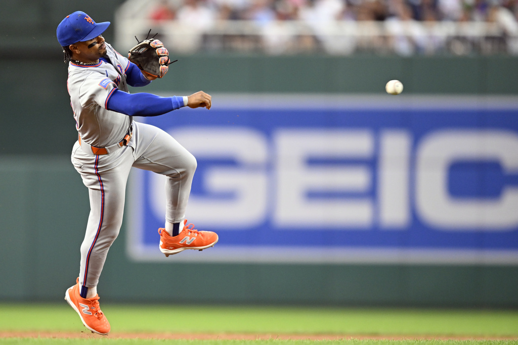 New York Mets shortstop Francisco Lindor throw out Washington Nationals Dylan Crews at first base during the second inning of a baseball game Tuesday, Aug. 19, 2025, in Washington. (AP Photo/John McDonnell)