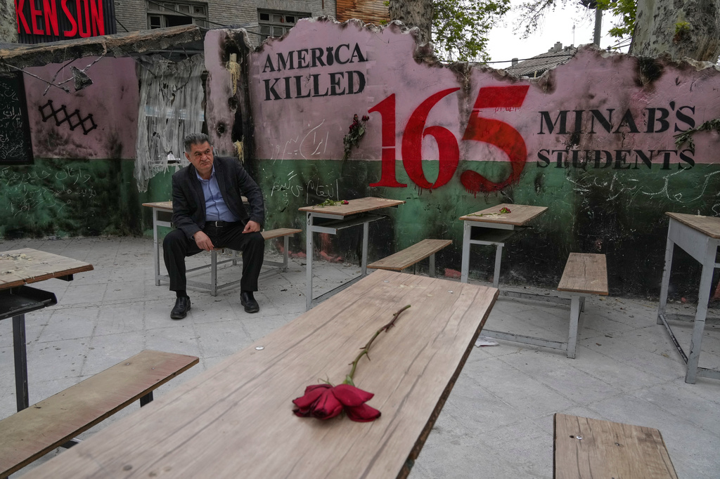 FILE - A man sits on a bench in a memorial, set for the school children who were killed during a strike on a school in southern town of Minab on Feb. 28, in northern Tehran, Iran, Sunday, April 12, 2026. (AP Photo/Vahid Salemi, File)